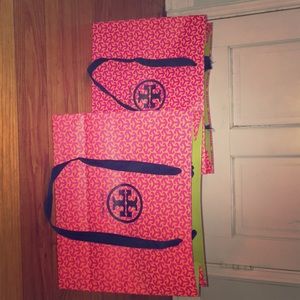 Two Tory Burch shopping bags.
